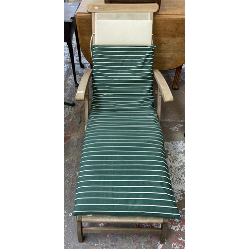 127 - A teak and plastic woven steamer sun lounger