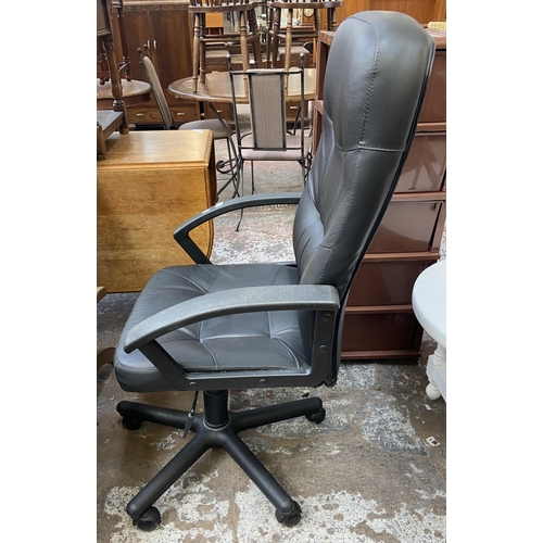 128 - A modern black leatherette and plastic swivel office desk chair