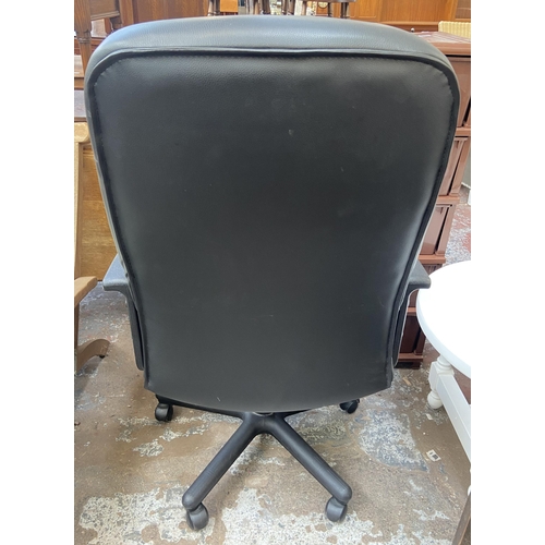 128 - A modern black leatherette and plastic swivel office desk chair