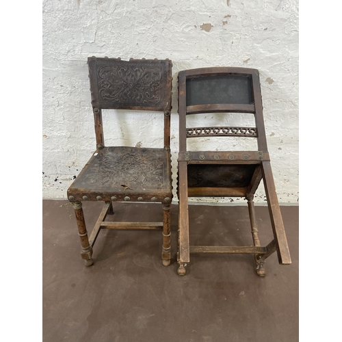 129 - A pair of Cromwellian style carved beech and brown leather dining chairs