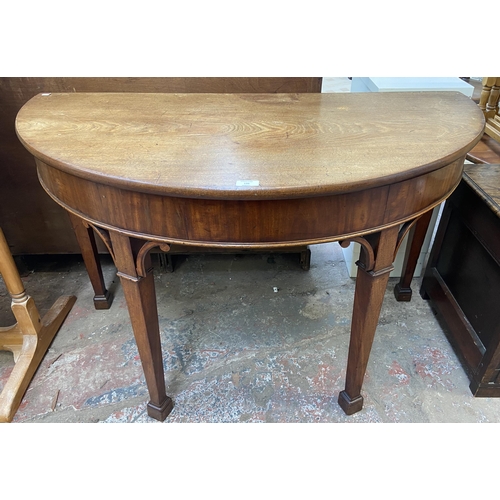 135 - A George III mahogany demi lune hall table - approx. 73cm high x 118cm wide x 60cm deep