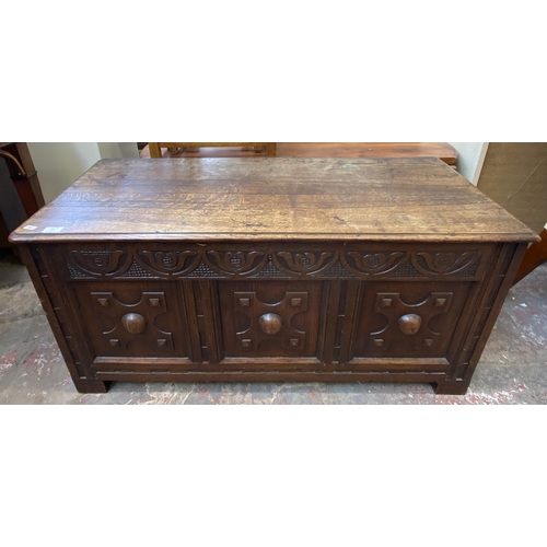 137 - A Georgian carved oak blanket box - approx. 52cm high x 107cm wide x 48cm deep