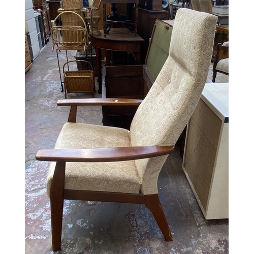 138 - A mid 20th century Parker Knoll PK1071-74 teak and fabric upholstered armchair