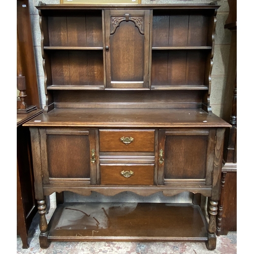 14 - A carved oak dresser - approx. 168cm high x 127cm wide x 50cm deep