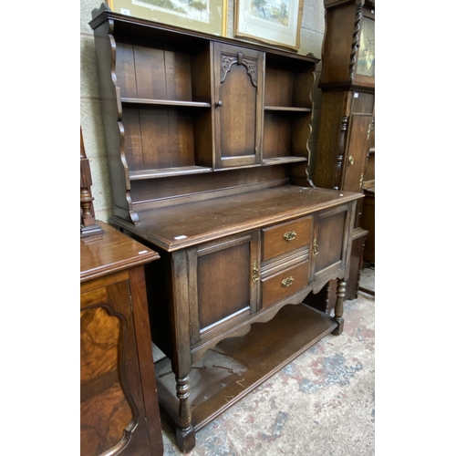 14 - A carved oak dresser - approx. 168cm high x 127cm wide x 50cm deep