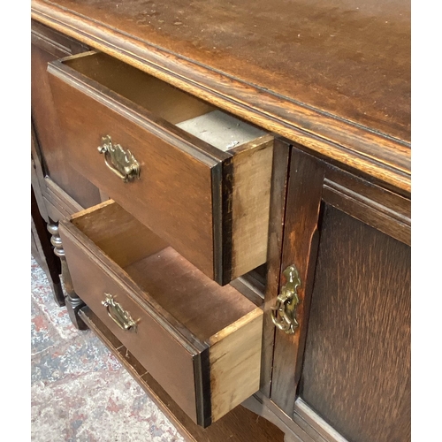 14 - A carved oak dresser - approx. 168cm high x 127cm wide x 50cm deep