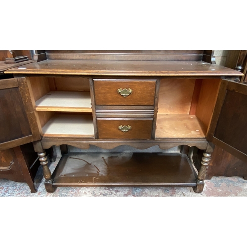 14 - A carved oak dresser - approx. 168cm high x 127cm wide x 50cm deep