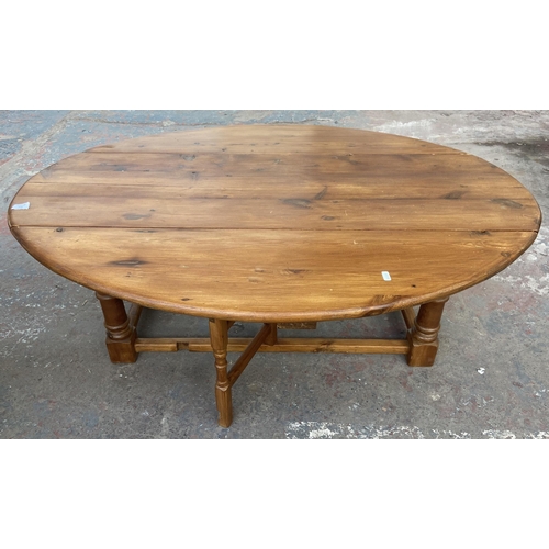 141 - Three pieces of furniture, one pine drop leaf oval coffee table, one Mexican pine side table and one... 