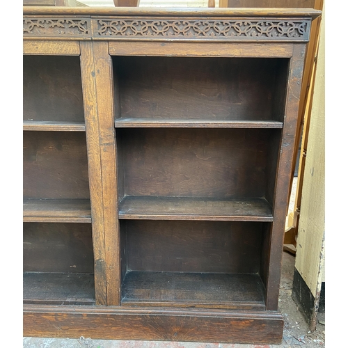 144 - An early 20th century carved oak six section bookcase - approx. 100cm high x 116cm wide x 21cm deep