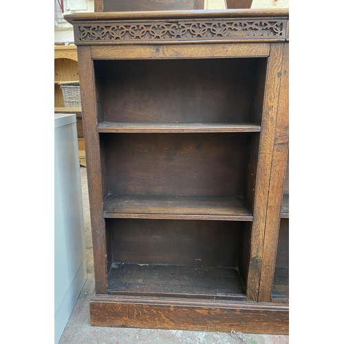 144 - An early 20th century carved oak six section bookcase - approx. 100cm high x 116cm wide x 21cm deep