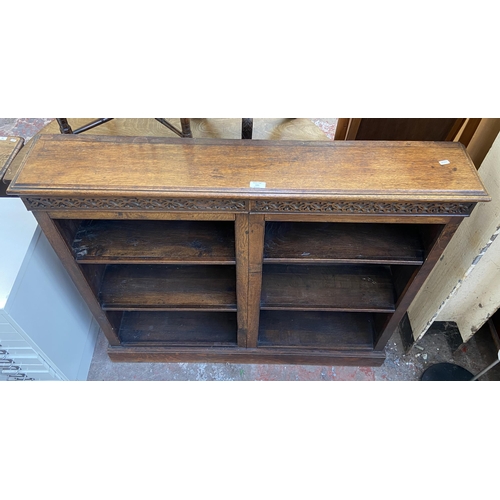 144 - An early 20th century carved oak six section bookcase - approx. 100cm high x 116cm wide x 21cm deep