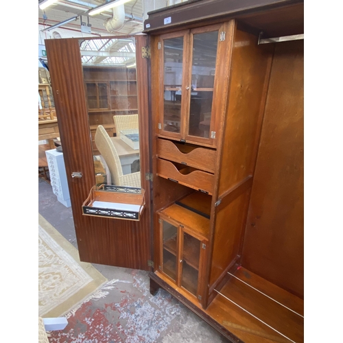 146 - A 1920s mahogany compactum double wardrobe with fitted interior - approx. 181cm high x 117cm wide x ... 