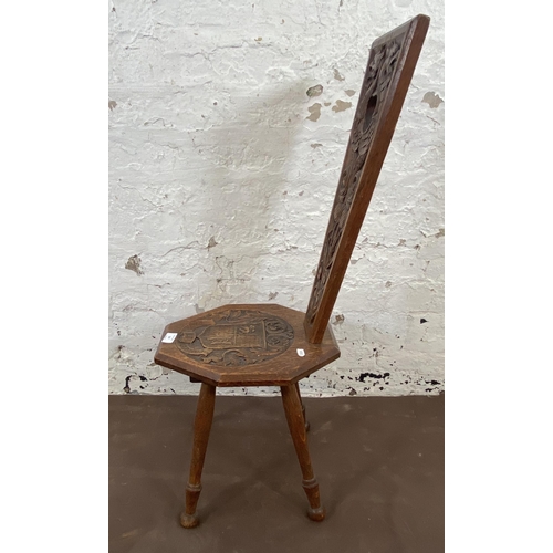 147 - A carved oak spinning chair - approx. 85cm high