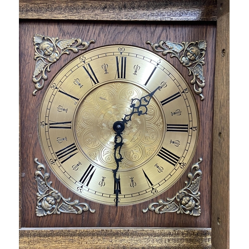 15 - A Georgian style oak cased grandfather clock with barley twist design, brass face and pendulum - app... 