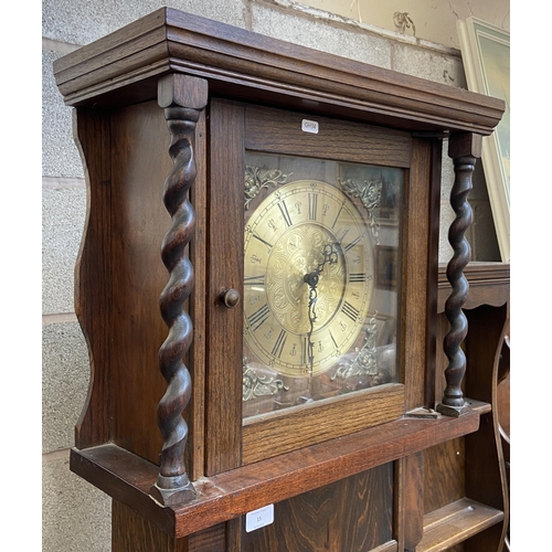 15 - A Georgian style oak cased grandfather clock with barley twist design, brass face and pendulum - app... 