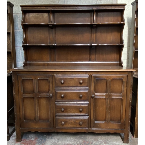 18 - An Ercol Old Colonial elm dresser - approx. 169cm high x 142cm wide x 50cm deep