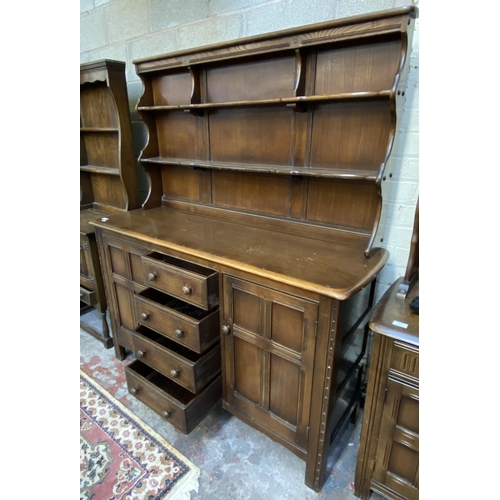 18 - An Ercol Old Colonial elm dresser - approx. 169cm high x 142cm wide x 50cm deep