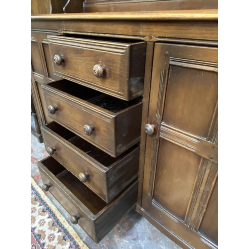 18 - An Ercol Old Colonial elm dresser - approx. 169cm high x 142cm wide x 50cm deep