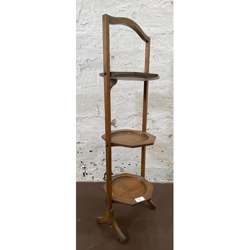 20 - An early 20th century oak three tier folding cake stand - approx. 82cm high