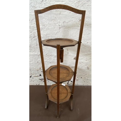 20 - An early 20th century oak three tier folding cake stand - approx. 82cm high