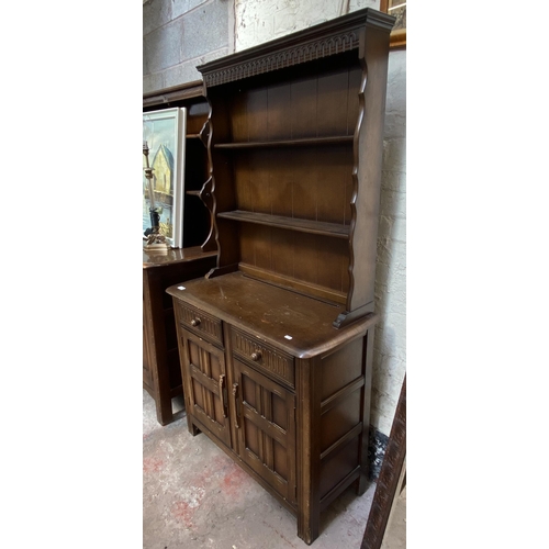 21 - A carved oak dresser - approx. 172cm high x 91cm wide x 41cm deep