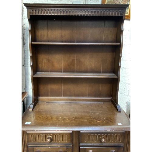 21 - A carved oak dresser - approx. 172cm high x 91cm wide x 41cm deep