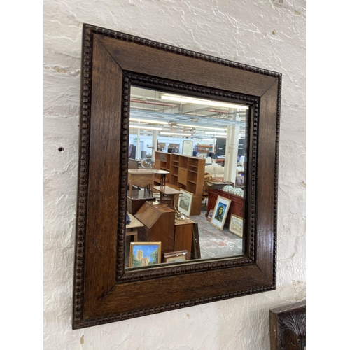 23 - Three early 20th century framed wall mirrors, two oak and one mahogany - largest approx. 90cm high x... 