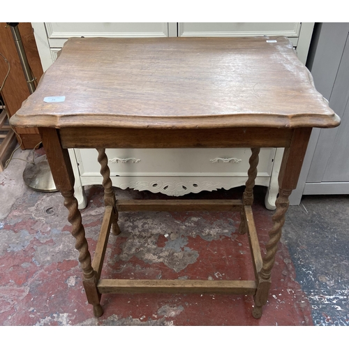 25 - An oak serpentine barley twist side table - approx. 72cm high x 59cm wide x 42cm deep