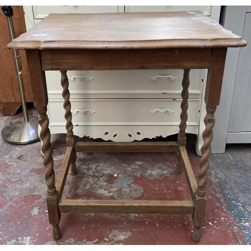 25 - An oak serpentine barley twist side table - approx. 72cm high x 59cm wide x 42cm deep