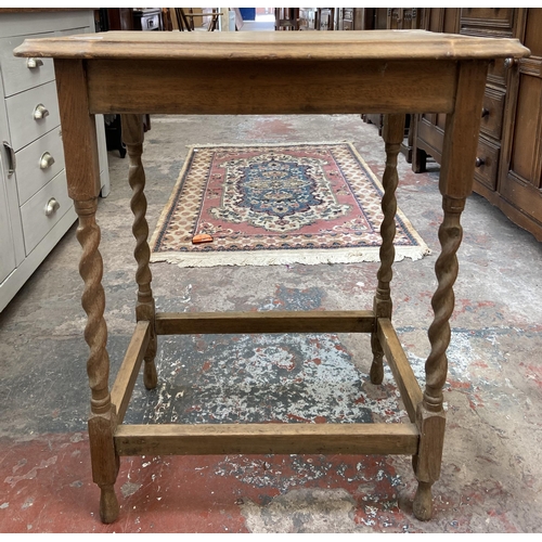 25 - An oak serpentine barley twist side table - approx. 72cm high x 59cm wide x 42cm deep