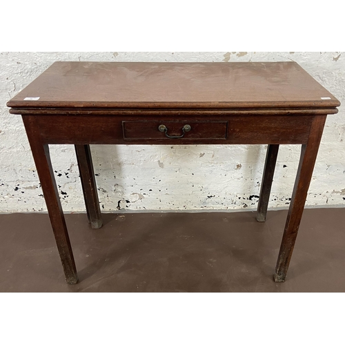 36 - A George III mahogany fold over tea table - approx. 74cm high x 90cm wide x 45cm deep