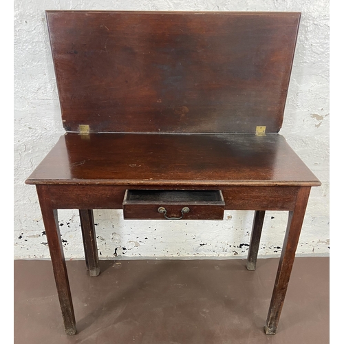 36 - A George III mahogany fold over tea table - approx. 74cm high x 90cm wide x 45cm deep