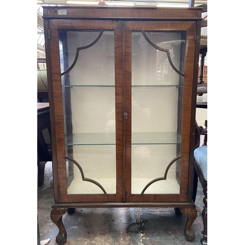 38 - An early 20th century walnut display cabinet on ball and claw supports - approx. 127cm high x 74cm w... 