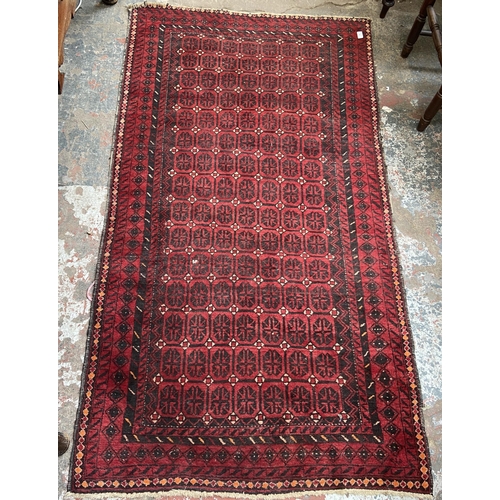 40 - A mid 20th century machine woven Afghan rug - approx. 183cm x 100cm