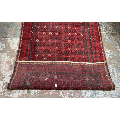 40 - A mid 20th century machine woven Afghan rug - approx. 183cm x 100cm