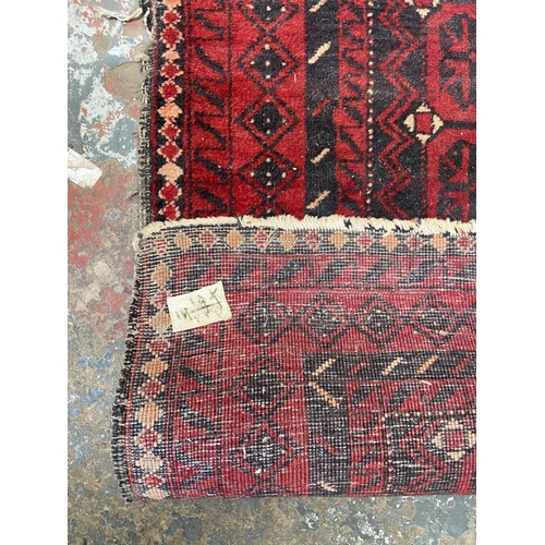 40 - A mid 20th century machine woven Afghan rug - approx. 183cm x 100cm