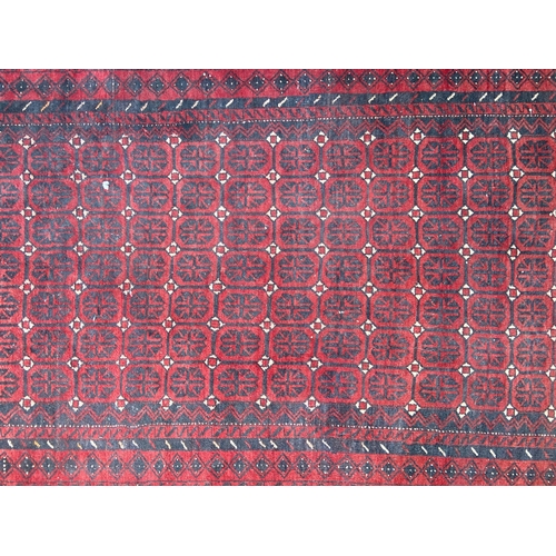 40 - A mid 20th century machine woven Afghan rug - approx. 183cm x 100cm