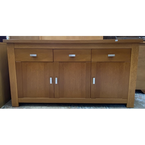 44 - A modern oak sideboard - approx. 80cm high x 150cm wide x 40cm deep