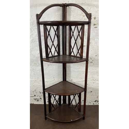 49 - A wicker and cane four tier corner shelving unit - approx. 151cm high