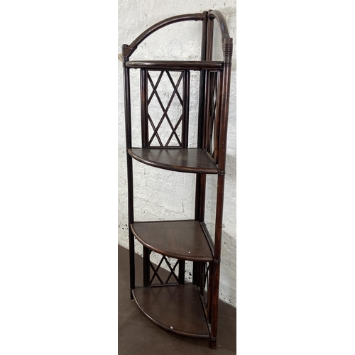 49 - A wicker and cane four tier corner shelving unit - approx. 151cm high