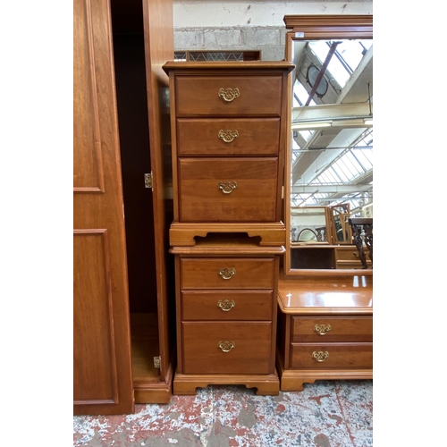 59 - A pair of Younger cherry wood bedside chests of drawers - approx. 68cm high x 47cm wide x 46cm deep