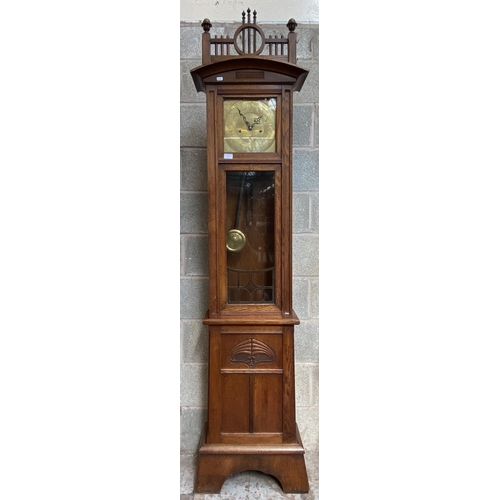 6 - An Arts & Crafts carved oak cased eight day grandfather clock with pendulum - approx. 214cm high x 5... 