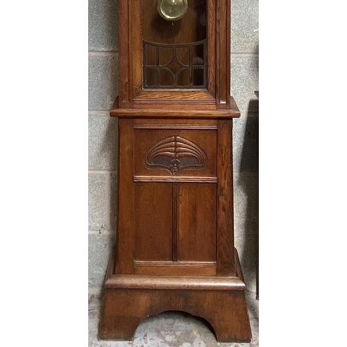 6 - An Arts & Crafts carved oak cased eight day grandfather clock with pendulum - approx. 214cm high x 5... 