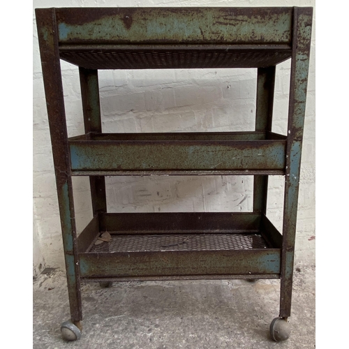 7 - A mid 20th century green metal industrial three tier trolley - approx. 86cm high x 30cm wide x 61cm ... 