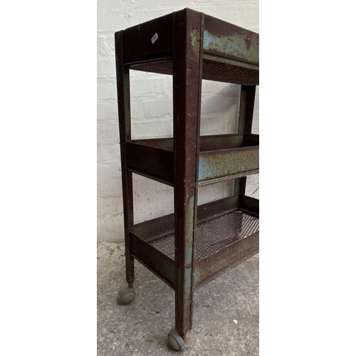 7 - A mid 20th century green metal industrial three tier trolley - approx. 86cm high x 30cm wide x 61cm ... 