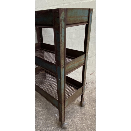 7 - A mid 20th century green metal industrial three tier trolley - approx. 86cm high x 30cm wide x 61cm ... 