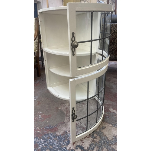 76 - A mid 20th century white painted and lead glazed wall mountable two door corner display cabinet