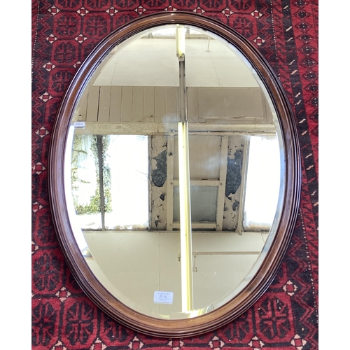 8A - An Edwardian mahogany framed bevelled edge oval wall mirror - approx. 90cm high x 60cm wide