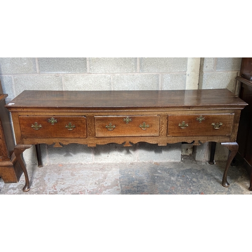 9 - A George III oak three drawer dresser base on cabriole supports - approx. 80cm high x 190cm wide x 4... 