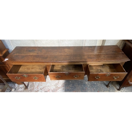 9 - A George III oak three drawer dresser base on cabriole supports - approx. 80cm high x 190cm wide x 4... 